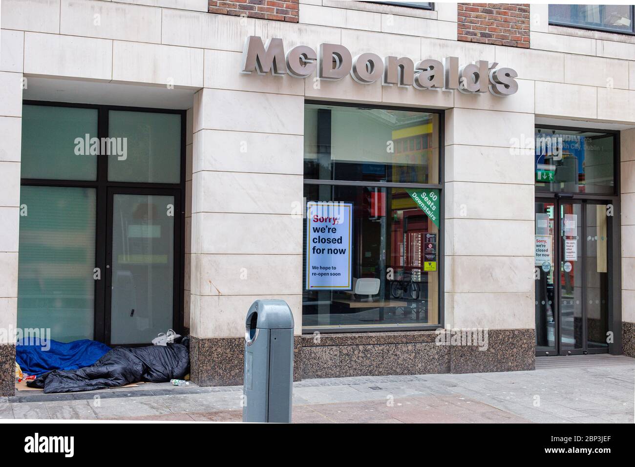 Homeless people sleeping in the doorway of closed due to Covid-19 pandemic McDonald`s restaurant on Henry Street in Dublin, Ireland Stock Photo